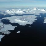 Aerial view of Antarctica showing research stations and pristine landscapes, illustrating potential business ideas in Antarctica